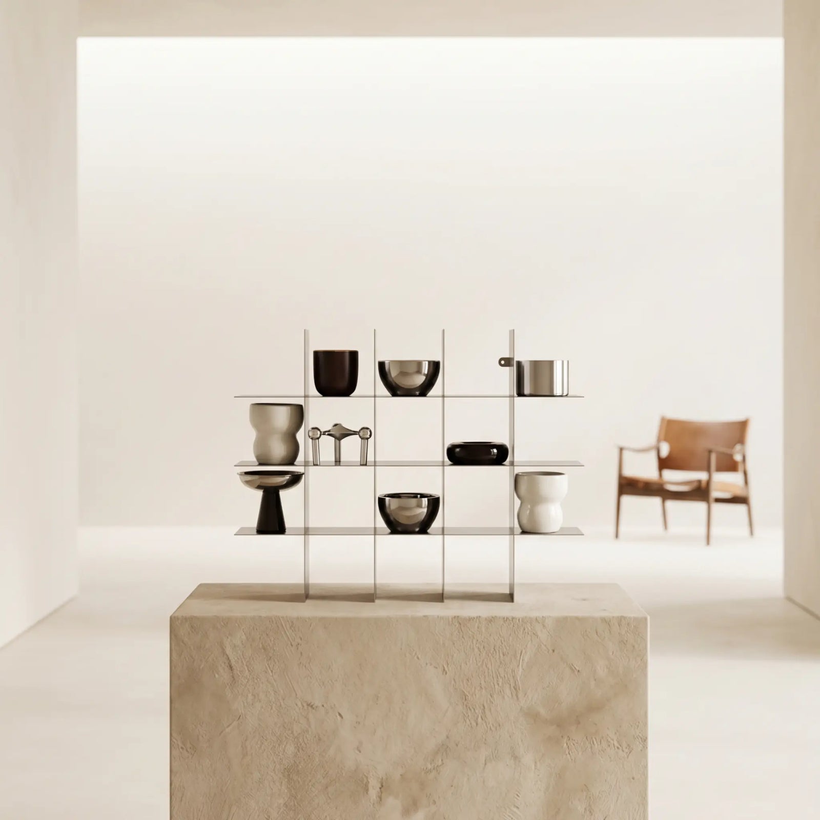 Modular metal shelf on a stone pedestal in a bright minimalist room
