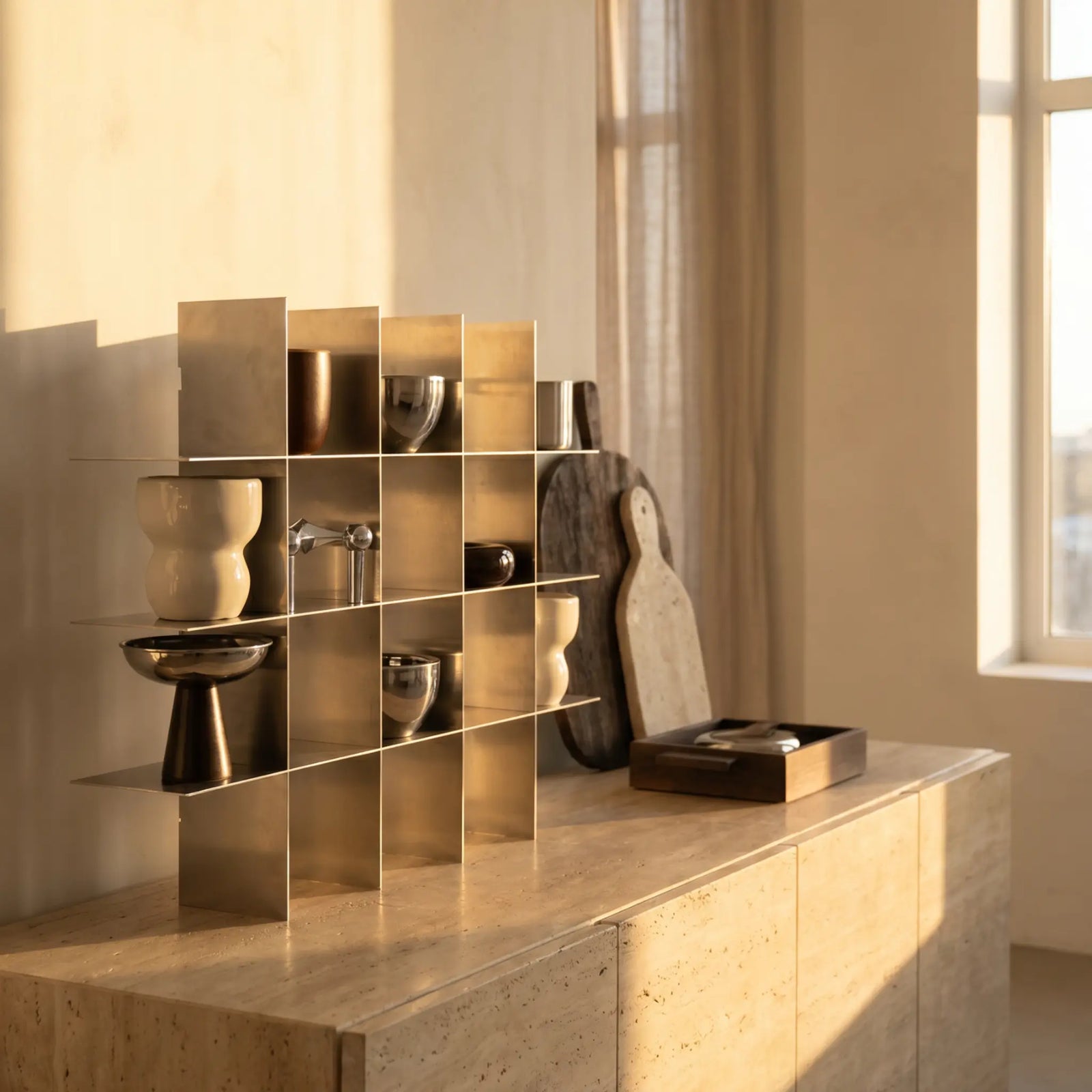 Metal shelf with decorative objects on a sideboard in warm evening light