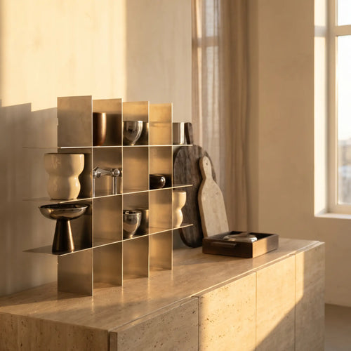 Metal shelf with decorative objects on a sideboard in warm evening light