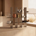 Modern stainless steel mug shelf styled in a warm beige interior with decorative mugs and minimalist home decor.